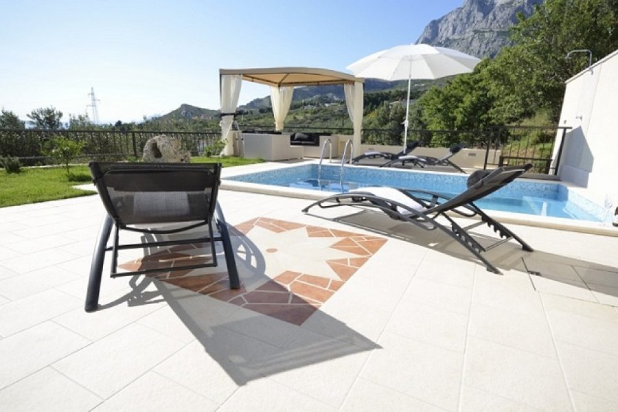 Pool with sun lounges at villa Majda